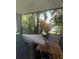 Relaxing screened balcony showcasing verdant views of palm trees and tropical foliage; inviting outdoor living at 11201 122Nd Ave # 129, Largo, FL 33778