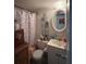 Cozy bathroom with a flamingo-themed shower curtain and vintage vanity at 11201 122Nd Ave # 129, Largo, FL 33778