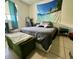 Comfortable bedroom with beach tapestry and tiled floors at 11201 122Nd Ave # 129, Largo, FL 33778