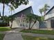 Community clubhouse entrance with American flag and white picket fence at 11201 122Nd Ave # 129, Largo, FL 33778