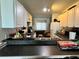 Functional kitchen with ample cabinet space and a view into the cozy living area at 11201 122Nd Ave # 129, Largo, FL 33778