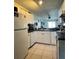 Well-lit kitchen featuring white cabinetry and efficient layout, perfect for everyday cooking and meal prep at 11201 122Nd Ave # 129, Largo, FL 33778