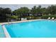 Enjoy community pool with water view, lounge chairs, and a tranquil setting, perfect for relaxation and recreation at 11201 122Nd Ave # 129, Largo, FL 33778