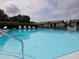 Community pool with lounge chairs overlooking a well-maintained landscape at 11201 122Nd Ave # 129, Largo, FL 33778