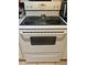 Close-up of a classic white electric stove, ready for cooking at 11201 122Nd Ave # 129, Largo, FL 33778