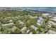 Aerial view of a community with lush green trees near the bay and waterway at 11440 Harbor Way # 5009, Largo, FL 33774