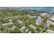 Aerial view showing the community surrounded by trees, with a water view, and lush, green landscaping at 11440 Harbor Way # 5009, Largo, FL 33774