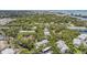 An aerial view shows the community is surrounded by lush greenery with views of the bay in the distance at 11440 Harbor Way # 5009, Largo, FL 33774