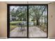 Back patio view through sliding glass doors showcasing a serene pond with a fountain at 11440 Harbor Way # 5009, Largo, FL 33774
