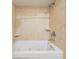 Bathroom with jacuzzi tub and shower with beige tile surround at 11440 Harbor Way # 5009, Largo, FL 33774