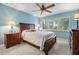 Comfortable bedroom with blue walls, decorative ceiling fan and natural light from the shuttered window at 11440 Harbor Way # 5009, Largo, FL 33774