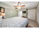 Cozy bedroom features a ceiling fan, TV, and closet for ample storage at 11440 Harbor Way # 5009, Largo, FL 33774