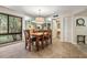 Bright dining area featuring a wooden table, seating for six, and a large window with scenic views at 11440 Harbor Way # 5009, Largo, FL 33774