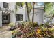 Exterior view of condo entrance adorned with tropical plants, providing privacy and a natural aesthetic at 11440 Harbor Way # 5009, Largo, FL 33774