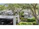 Exterior of condominium showing covered parking, mature landscaping and a welcoming entrance at 11440 Harbor Way # 5009, Largo, FL 33774