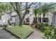Attractive condo exterior featuring mature trees, well-manicured landscaping, and a welcoming entrance at 11440 Harbor Way # 5009, Largo, FL 33774