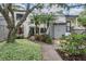 Inviting condo exterior with lush landscaping, palm trees, and a charming walkway at 11440 Harbor Way # 5009, Largo, FL 33774