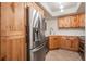 Well-equipped kitchen with stainless steel refrigerator and knotty wood cabinetry at 11440 Harbor Way # 5009, Largo, FL 33774