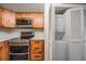 Efficient kitchen layout with modern stainless steel appliances and stacked washer/dryer unit at 11440 Harbor Way # 5009, Largo, FL 33774