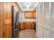 Open kitchen design with stainless steel appliances and abundant wood cabinet storage at 11440 Harbor Way # 5009, Largo, FL 33774