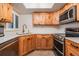 Well-lit kitchen features stainless steel appliances and wooden cabinets with white countertop at 11440 Harbor Way # 5009, Largo, FL 33774