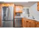 Modern kitchen with stainless steel appliances, bright white countertop and light wood cabinets at 11440 Harbor Way # 5009, Largo, FL 33774