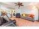 Bright living room features a ceiling fan, tile flooring, and comfortable seating with access to other rooms at 11440 Harbor Way # 5009, Largo, FL 33774