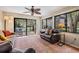 Bright sunroom with tile floors, large windows, and a peaceful outdoor view at 11440 Harbor Way # 5009, Largo, FL 33774