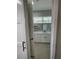 Bright bathroom featuring double vanity with marble countertop and floating shelves at 12308 Pittsfield Ave, Tampa, FL 33624