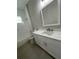Bathroom with white cabinets, drawers, brushed bronze faucet, white marble countertop, toilet, tub and tile floors at 12308 Pittsfield Ave, Tampa, FL 33624