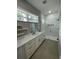 Bright bathroom with double vanity with marble countertop and glass-enclosed shower at 12308 Pittsfield Ave, Tampa, FL 33624