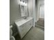 Bathroom featuring white cabinets, a marble countertop, and a glass shower door at 12308 Pittsfield Ave, Tampa, FL 33624
