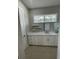 Bright bathroom featuring double vanity with marble countertop and floating shelves at 12308 Pittsfield Ave, Tampa, FL 33624