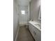 Bathroom featuring a tub and shower combo, white cabinets, drawers, marble countertop, and tile floors at 12308 Pittsfield Ave, Tampa, FL 33624