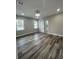 Bedroom with gray walls, wood flooring, and bright windows and a sliding door to a walk-in closet at 12308 Pittsfield Ave, Tampa, FL 33624