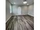 Spacious bedroom features wood-look flooring, neutral paint and stylish ceiling fan at 12308 Pittsfield Ave, Tampa, FL 33624
