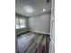 Bedroom features wood-look flooring, neutral paint, and modern ceiling fixture at 12308 Pittsfield Ave, Tampa, FL 33624