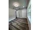 Bright bedroom with hardwood floors, fresh paint, white trim, ceiling fan and a window providing natural light at 12308 Pittsfield Ave, Tampa, FL 33624