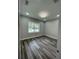Bedroom with hardwood floors, fresh paint, white trim, recessed lighting and a window providing natural light at 12308 Pittsfield Ave, Tampa, FL 33624