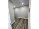 Empty walk-in closet featuring gray walls, wood flooring, and recessed lighting at 12308 Pittsfield Ave, Tampa, FL 33624