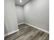 Clean and organized walk-in closet with modern flooring and neutral-colored walls at 12308 Pittsfield Ave, Tampa, FL 33624