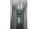 Hallway featuring modern light fixture and doors to multiple rooms at 12308 Pittsfield Ave, Tampa, FL 33624