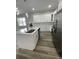 Contemporary kitchen featuring white cabinets, quartz countertops, and stainless steel appliances at 12308 Pittsfield Ave, Tampa, FL 33624