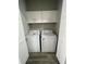 Convenient laundry room with white cabinetry and modern washer and dryer units at 12308 Pittsfield Ave, Tampa, FL 33624
