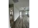 Open-concept living room with wood-look floors and modern finishes throughout at 12308 Pittsfield Ave, Tampa, FL 33624