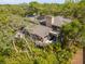 Expansive home featuring private balconies and lush surrounding foliage viewed from an aerial perspective at 1296 Weybridge Ln, Dunedin, FL 34698
