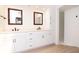 Bright primary bathroom featuring dual vanity, sleek fixtures, and walk-in shower at 1296 Weybridge Ln, Dunedin, FL 34698