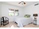 Bright bedroom features clean white walls and a modern ceiling fan at 1296 Weybridge Ln, Dunedin, FL 34698