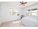 Bright bedroom features clean white walls and modern ceiling fan at 1296 Weybridge Ln, Dunedin, FL 34698