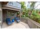 Outdoor deck featuring lounge chairs, railings, and beautiful natural landscape at 1296 Weybridge Ln, Dunedin, FL 34698